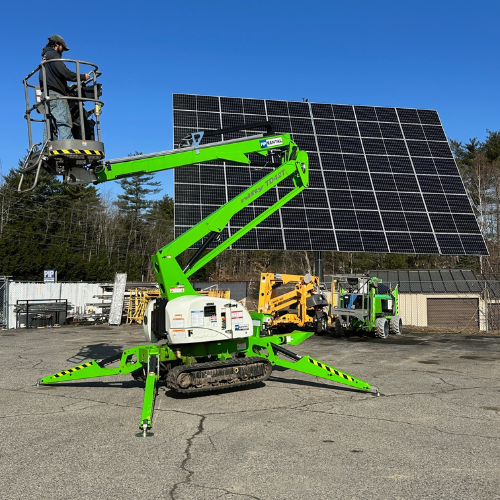 Rental equipment featuring a green boom lift