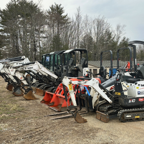 Rental equipment featuring skid steers and skid steer attachments.