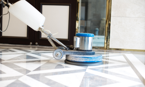 A close-up of a floor polisher being used.