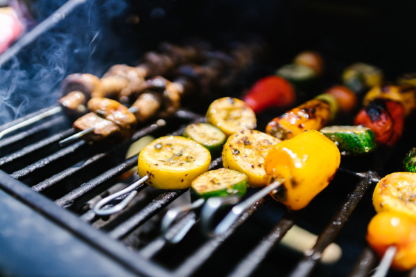 Vegetables on a skewer on a grill.
